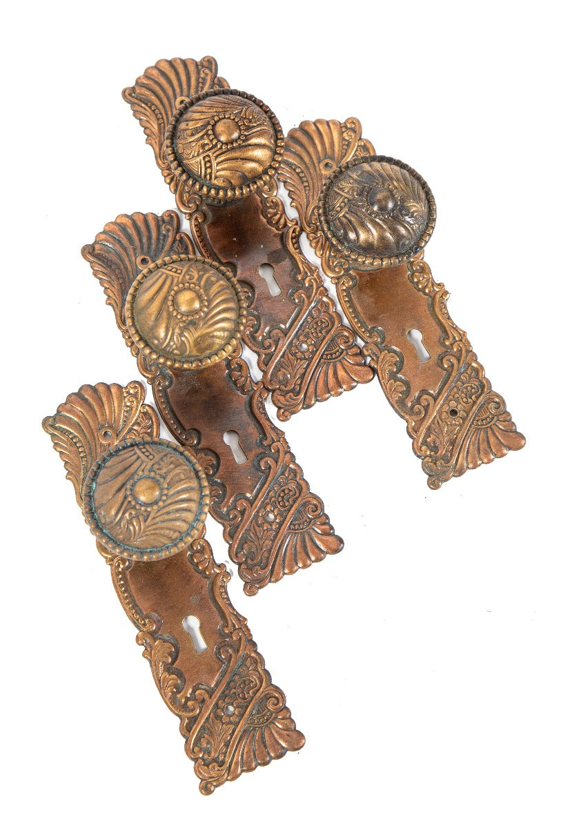 original late 19th or early 20th century ornamental wrought bronze "roanoke" pattern passage door backplates and matching handles