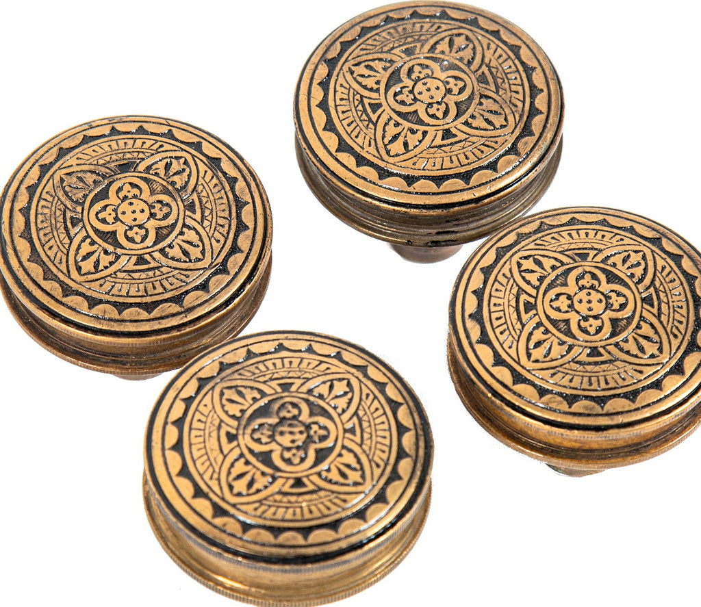 four matching all original 1880s gothic revival style ornamental cast bronze drum-shaped antique american residential doorknobs with black enameled inlay