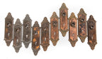 large lot of early 20th century ornamental cast iron "geneva" pattern interior residential doorknob backplates