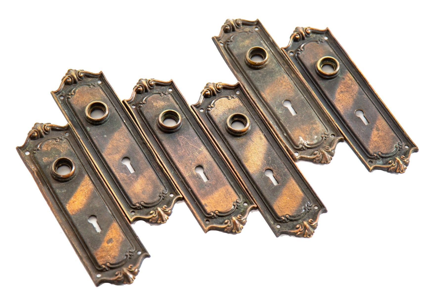 group of early 20th century antique american ornamental cast bronze residential passage door backplates with original copper-plated finish