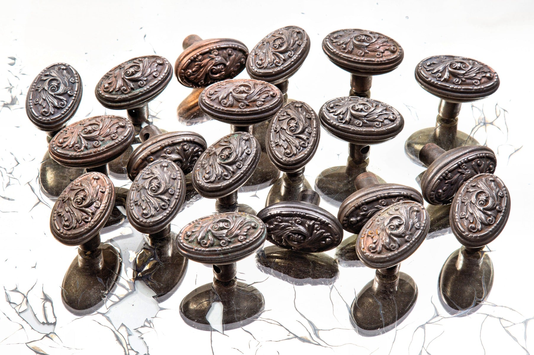 hard to find sizable lot of matching early 20th century antique american ornamental cast iron salvaged "arcadia" pattern oval-shaped doorknobs