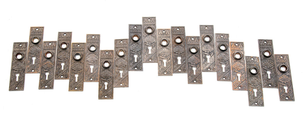 large lot of early 20th century antique american salvaged chicago "oriental" pattern ornamental cast iron doorknob backplates