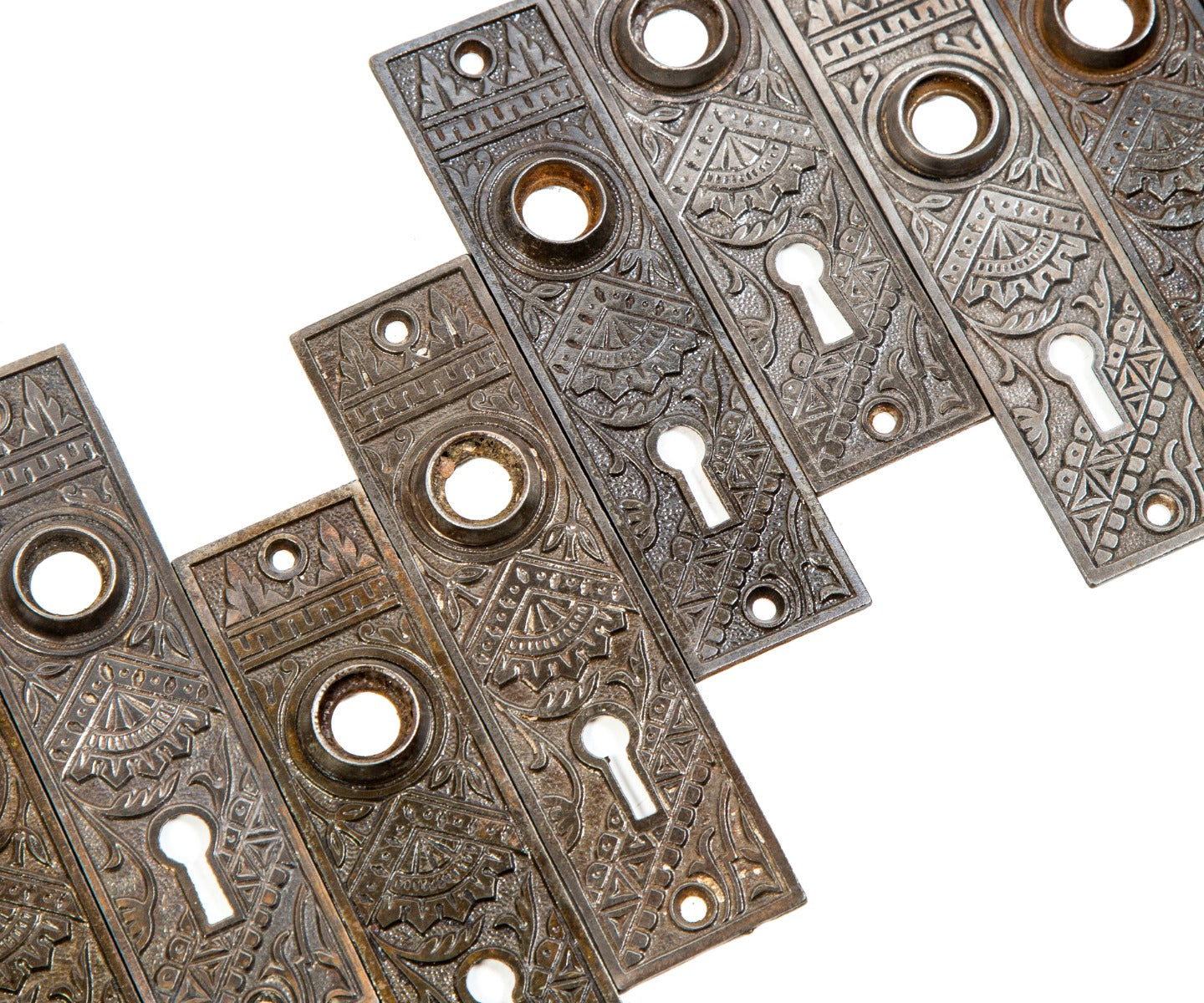 large lot of early 20th century antique american salvaged chicago "oriental" pattern ornamental cast iron doorknob backplates