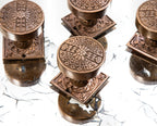 group of highly desirable antique american eastlake style ornamental cast bronze penn drum-shaped doorknobs and matching rosettes