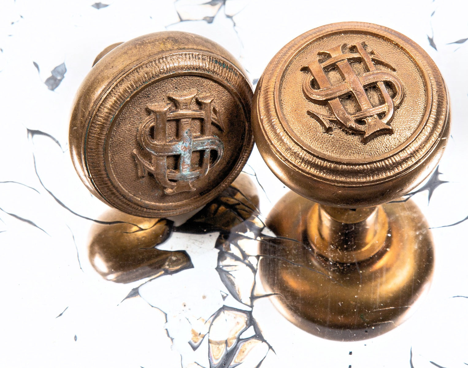 matching set of early 20th century cast bronze iowa state university institutional building monogrammed doorknobs