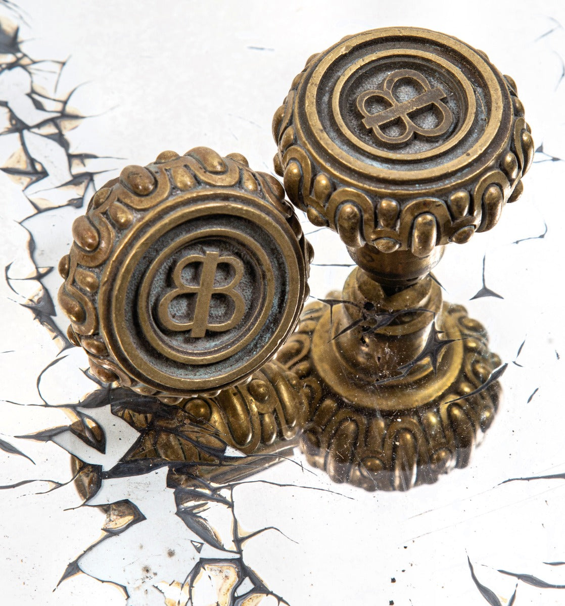 unusually-shaped heavy cast brass late 19th or early 20th century monogrammed baskin brothers new york city jewelry store doorknobs