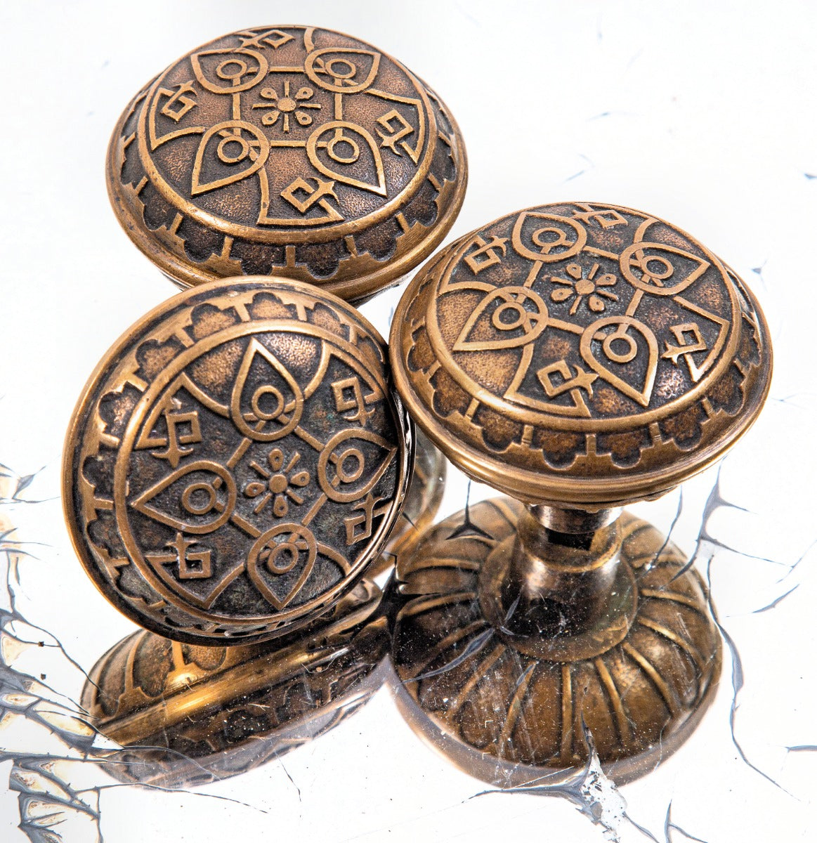 group of three matching hard to find 1880's ornamental cast bronze banded rim norwalk doorknobs with nicely aged patina