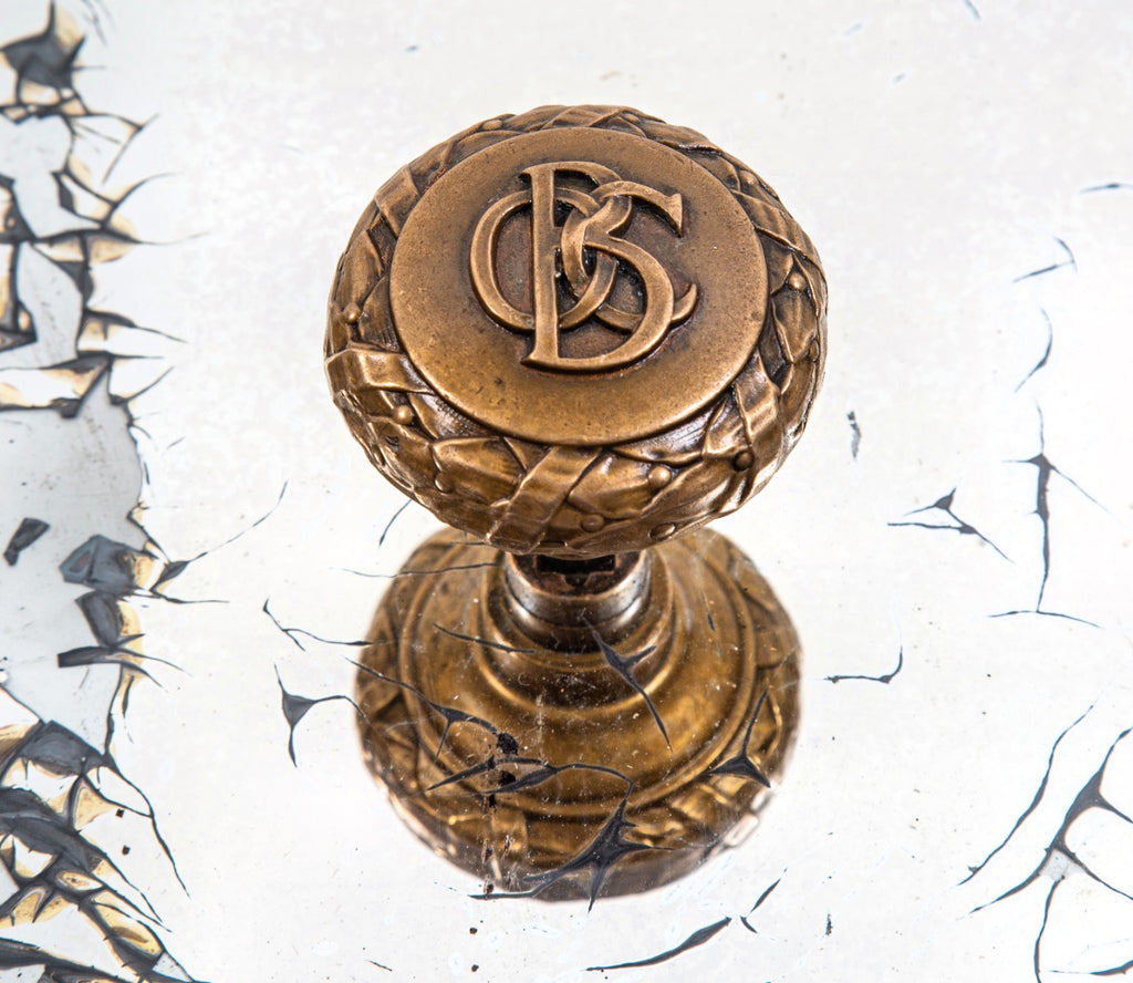 original late 19th century ornamental cast bronze monogrammed doorknob from holabird and roche's old colony building