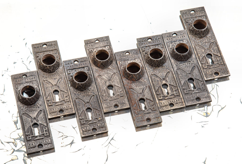 group of eight matching 1880s interior residential chicago hardware company doorknob backplates with oversized collars