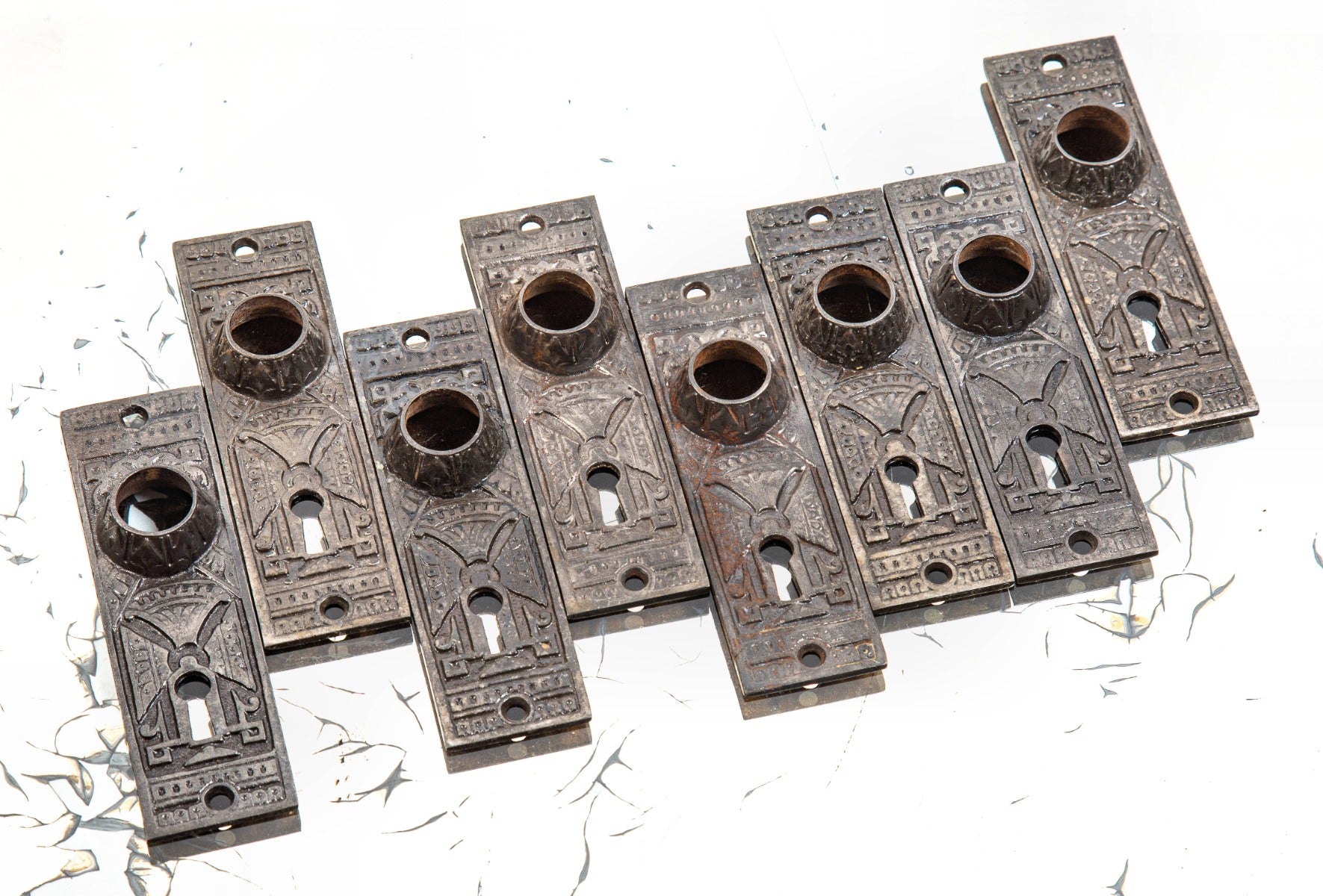 group of eight matching 1880s interior residential chicago hardware company doorknob backplates with oversized collars