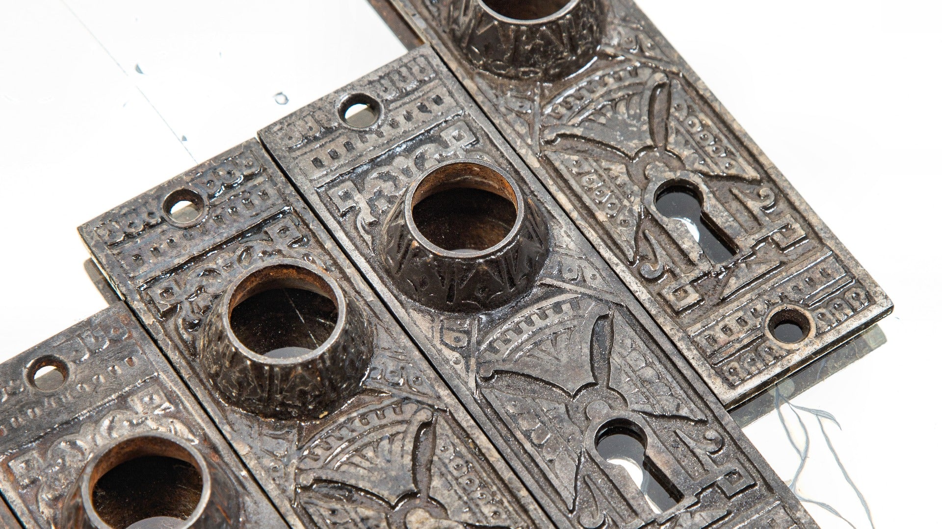 group of eight matching 1880s interior residential chicago hardware company doorknob backplates with oversized collars