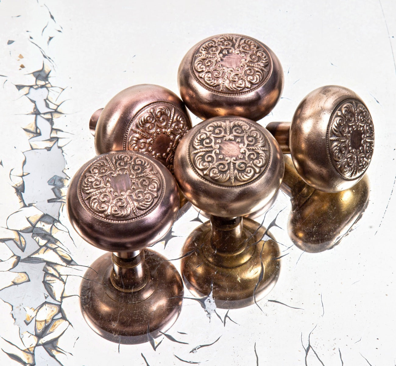 group of four matching early 20th century antique american ornamental cast brass "albemarle" pattern doorknobs by lockwood