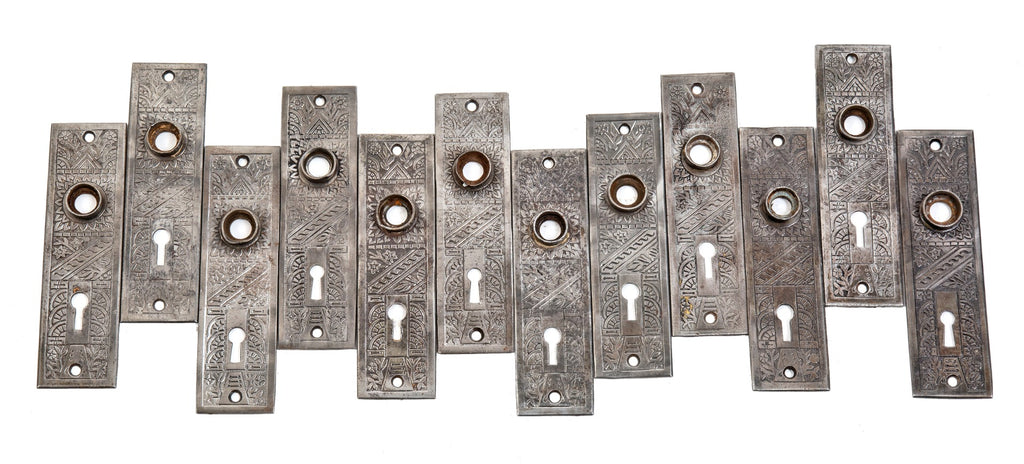 group of 8 matching late 19th century antique american salvaged chicago "windsor" pattern wrought steel doorknob backplates