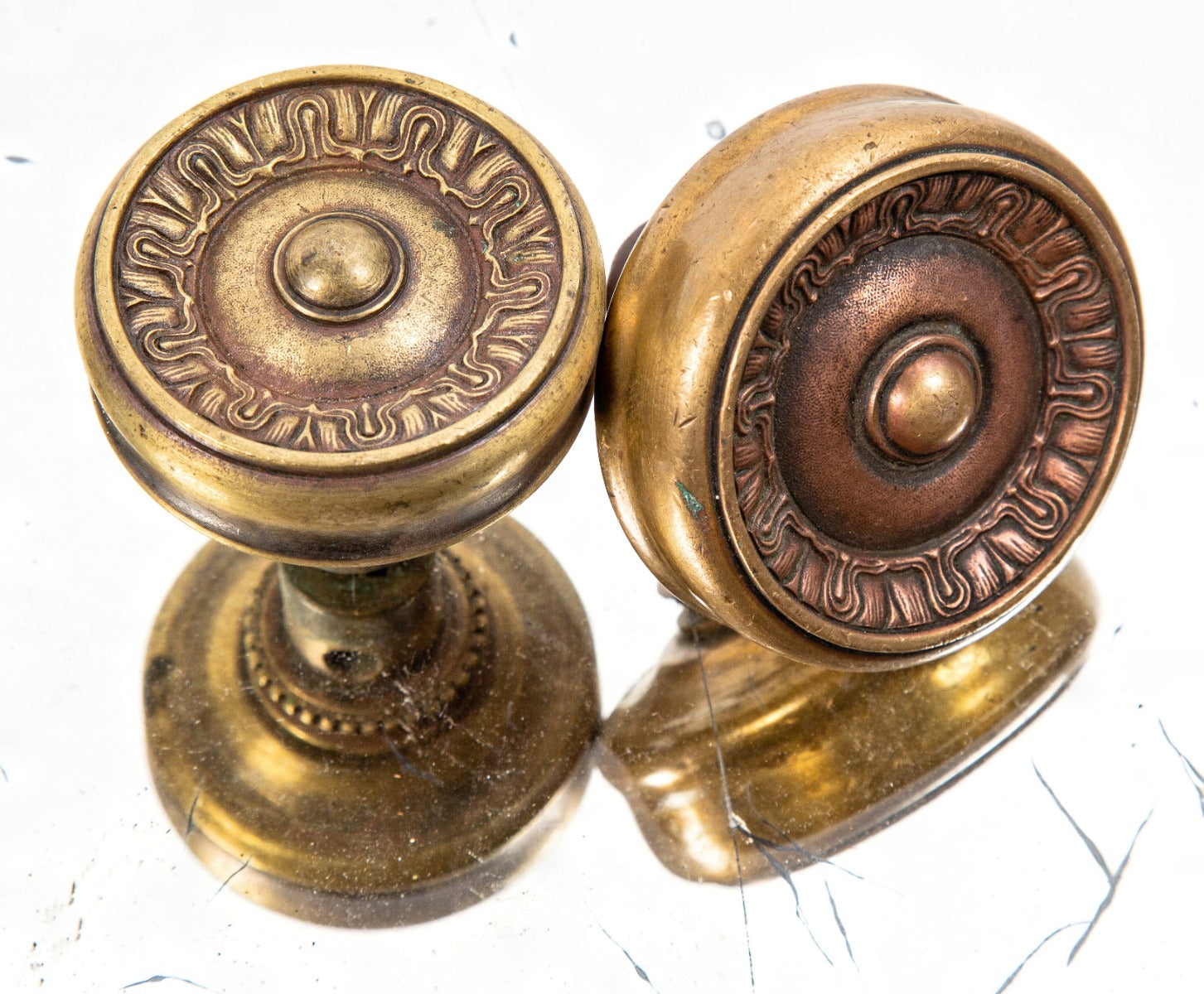 two matching 19th or early 20th century neoclassical style ornamental cast brass "genoa" pattern interior residential doorknobs