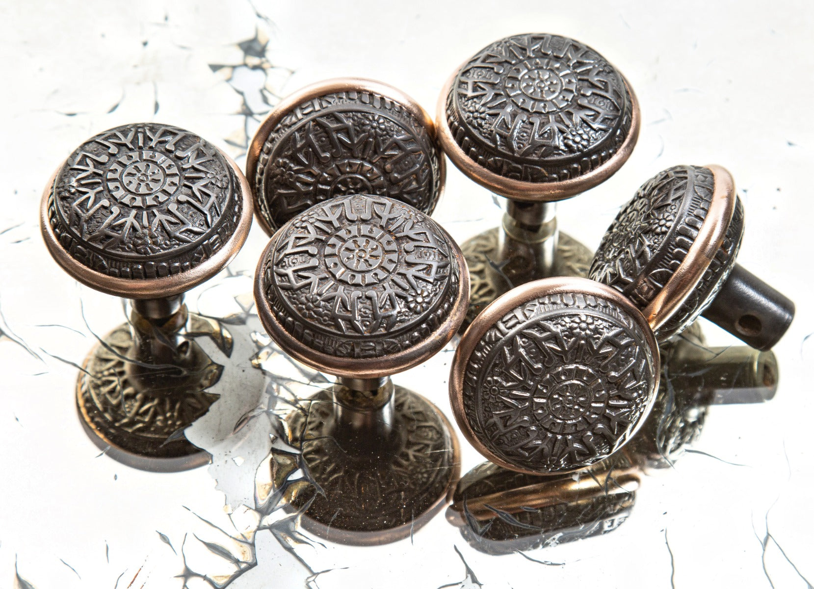 group of hard to find late 19th century eastlake style ornamental cast iron "windsor" pattern residential doorknobs with brass banding