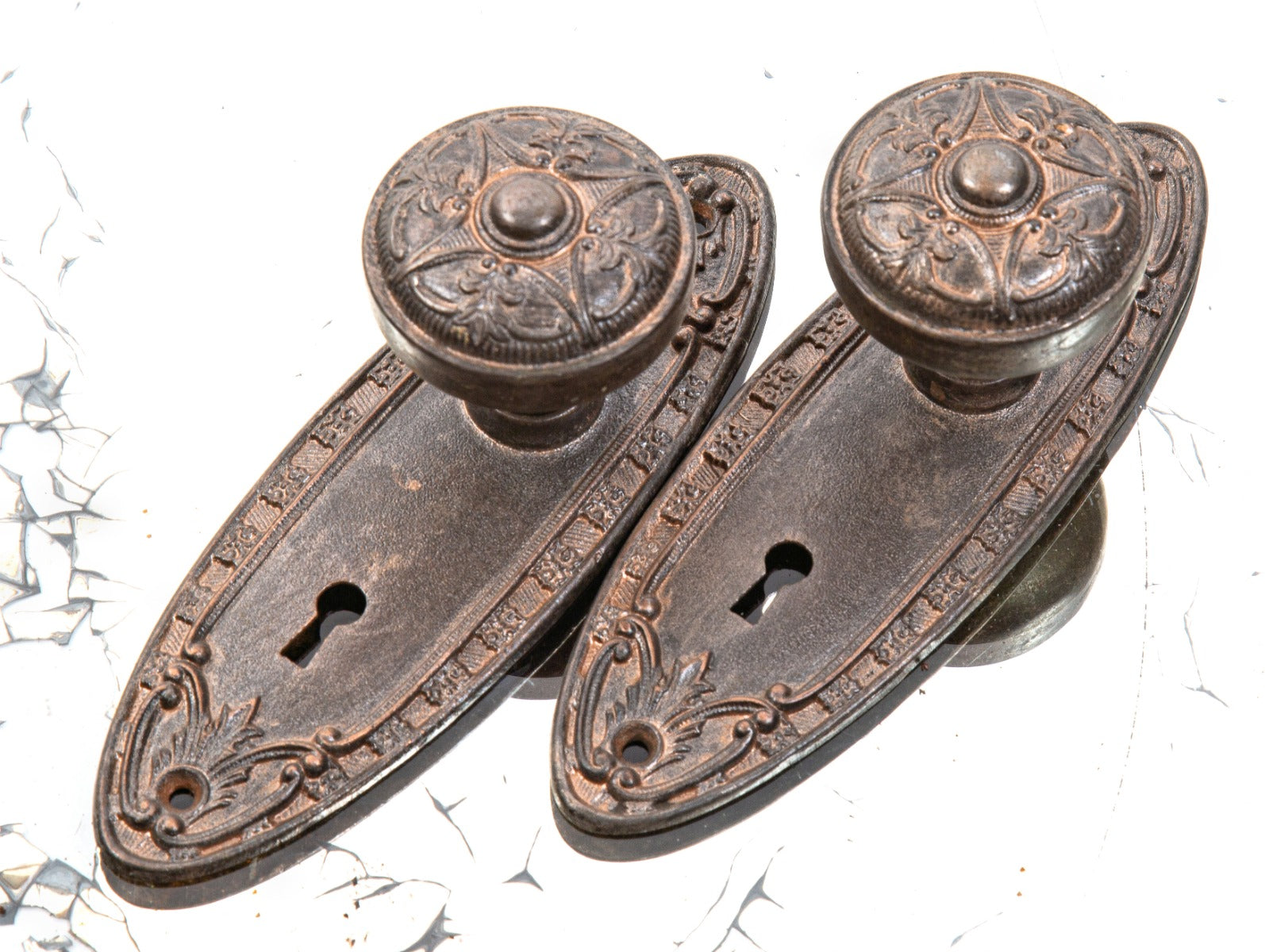 early 20th century salvaged chicago ornamental cast iron matching residential doorknobs and oval-shaped backplates