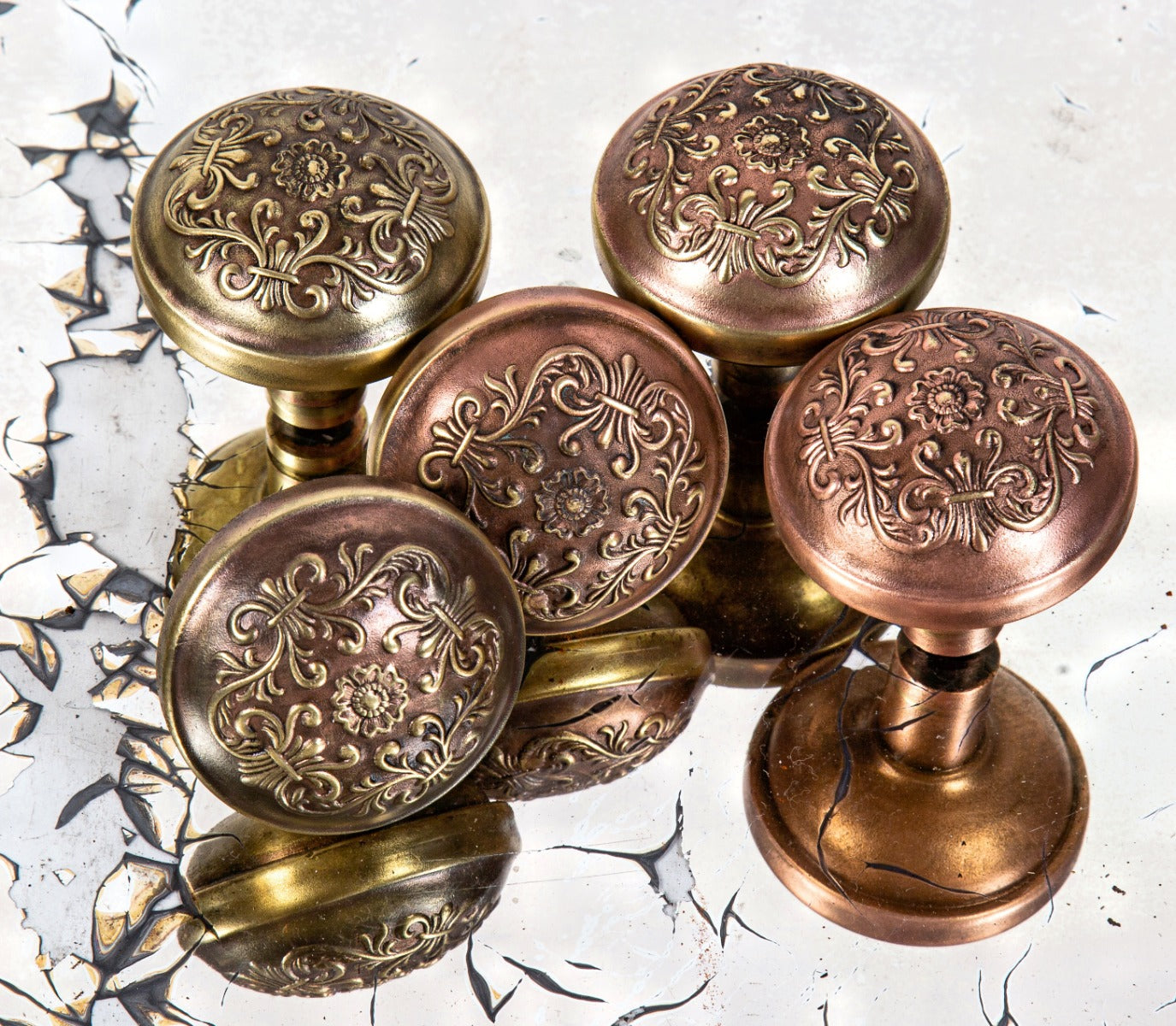 group of matching early 20th century ornamental wrought brass salvaged architectural doorknobs
