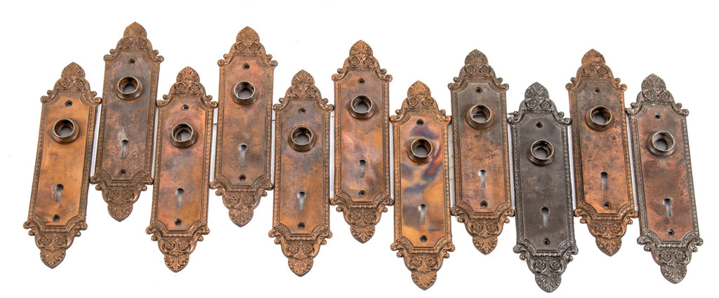 large lot of early 20th century ornamental cast iron copper-plated interior residential passage door backplates
