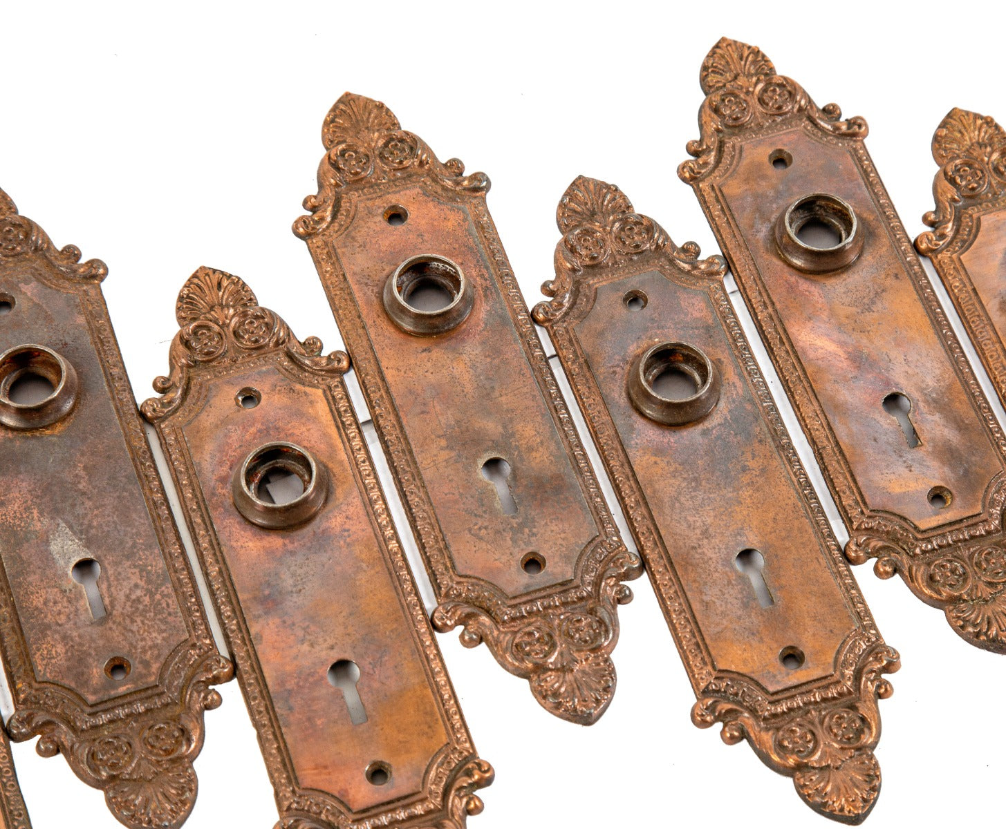 large lot of early 20th century ornamental cast iron copper-plated interior residential passage door backplates
