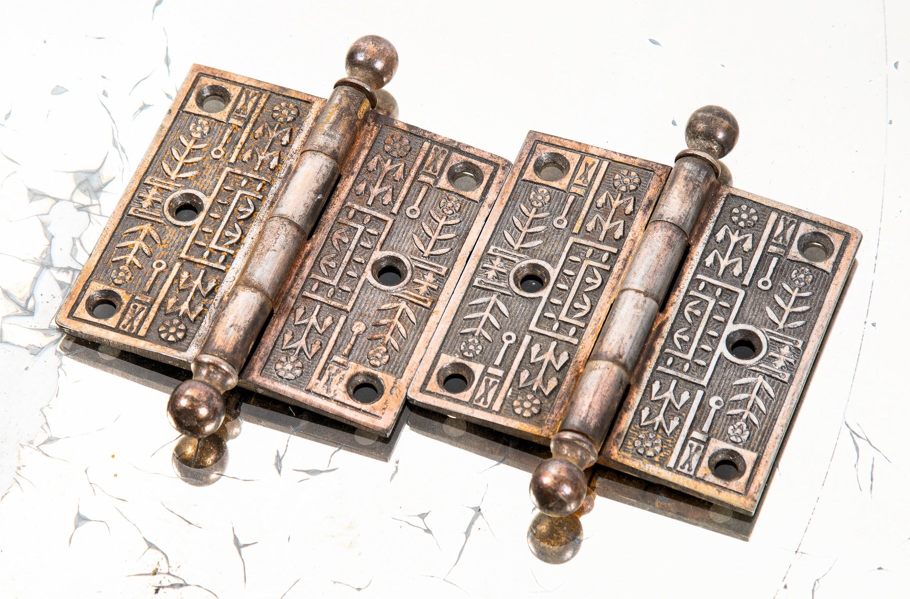 matching pair of original 19th century ornamental copper-plated cast iron salvaged chicago residential passage door hinges with ball finials