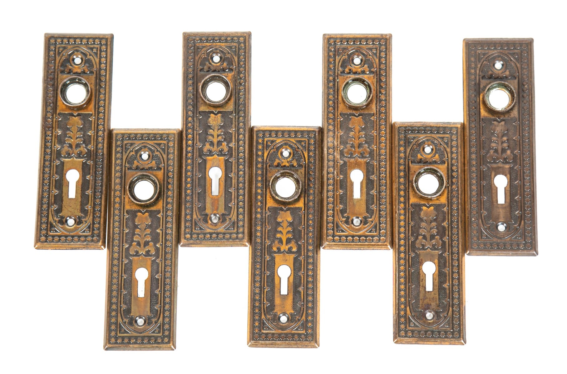 group of matching late 19th or early 20th century antique american copper-plated stamped steel doorknob backplates
