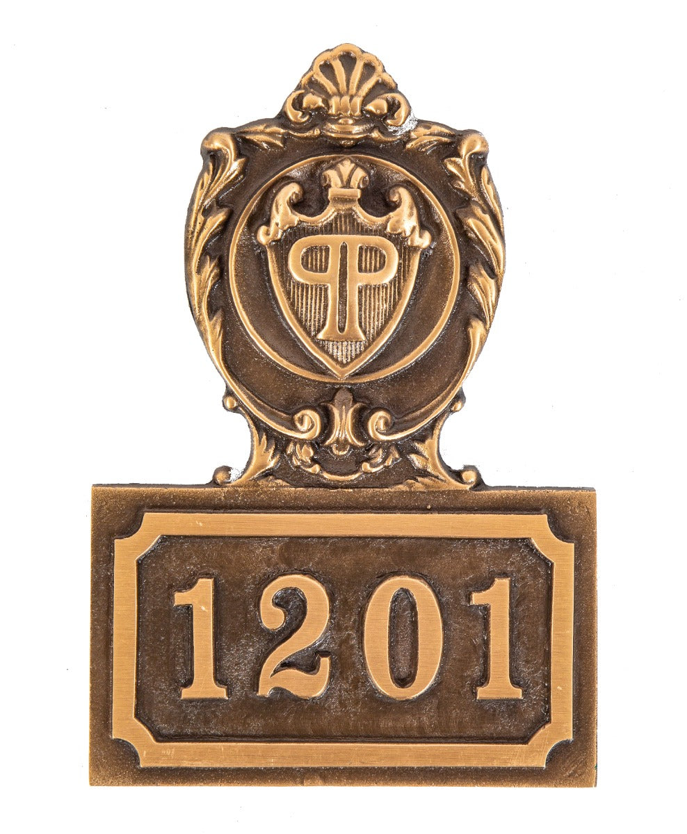 heavy single-sided cast bronze monogrammed new york city plaza hotel guest room number plaque executed by wagner