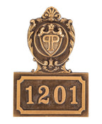 heavy single-sided cast bronze monogrammed new york city plaza hotel guest room number plaque executed by wagner