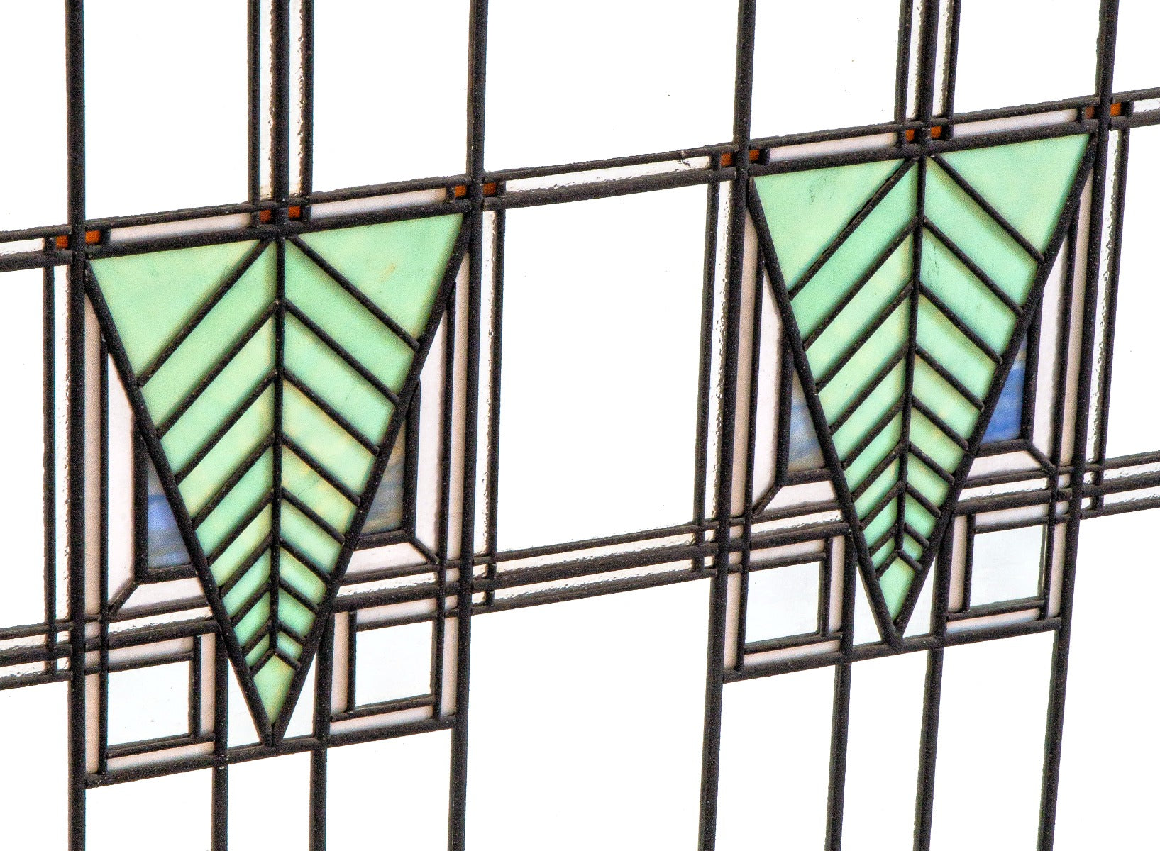 one of two matching strongly geometric early 20th century prairie style art glass window in the manner of george grant elmslie