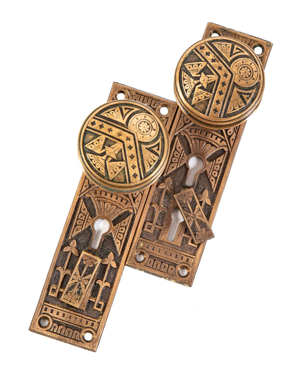 original 19th century ornamental cast brass "chevron" pattern residential entrance doorknobs and matching backplates