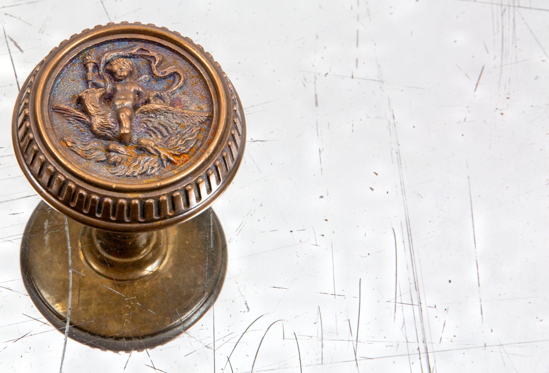 1880s american victorian era ornamental cast brass figural "cherub" residential doorknob with fluted design along hand's outer edge