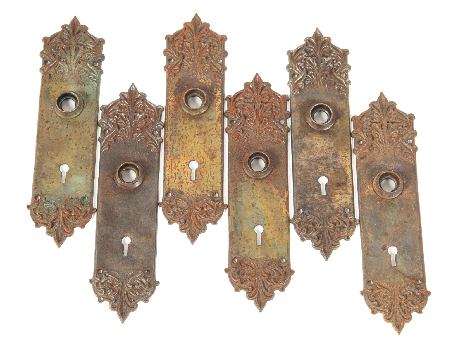 group of six matching early 20th century salvaged chicago ornamental cast iron "panama" pattern doorknob backplates