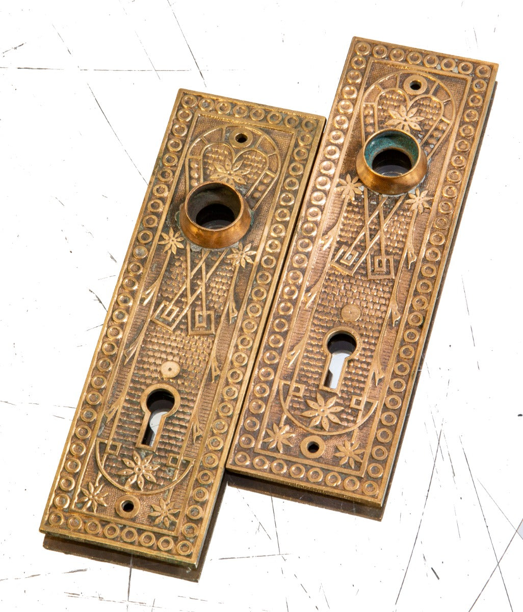 matching set of 19th century american eastlake style ornamental cast brass norwalk residential doorknob backplates