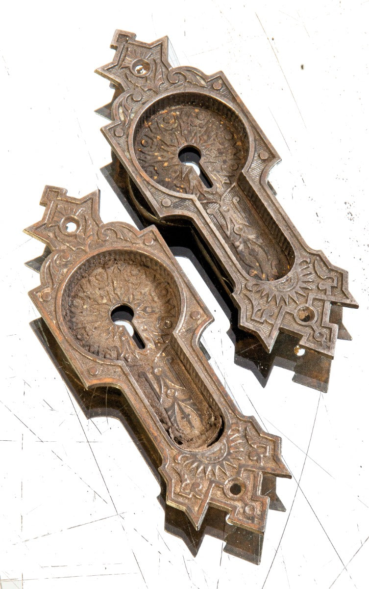 matching set of original 19th century lightly refinished ornamental cast iron residential pocket door handles or pulls