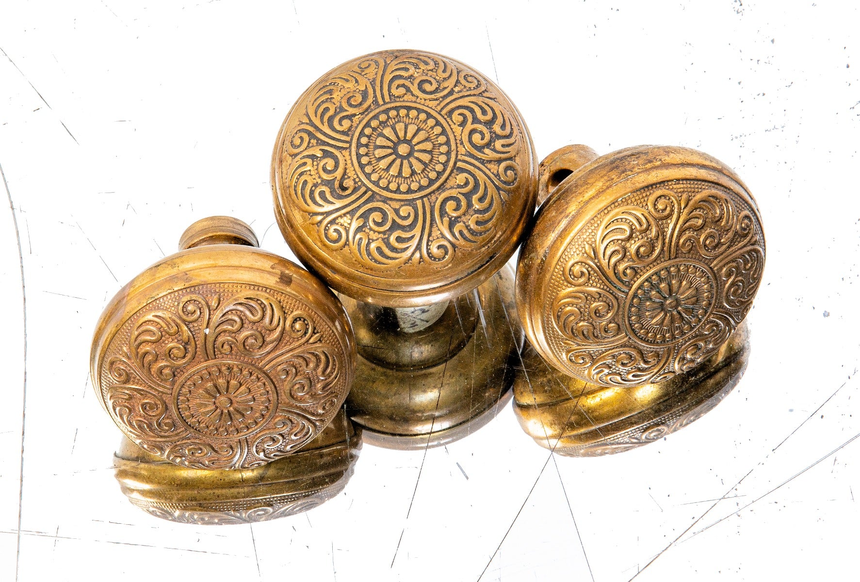 group of three matching ornamental wrought brass antique american "cairo" pattern residential doorknobs