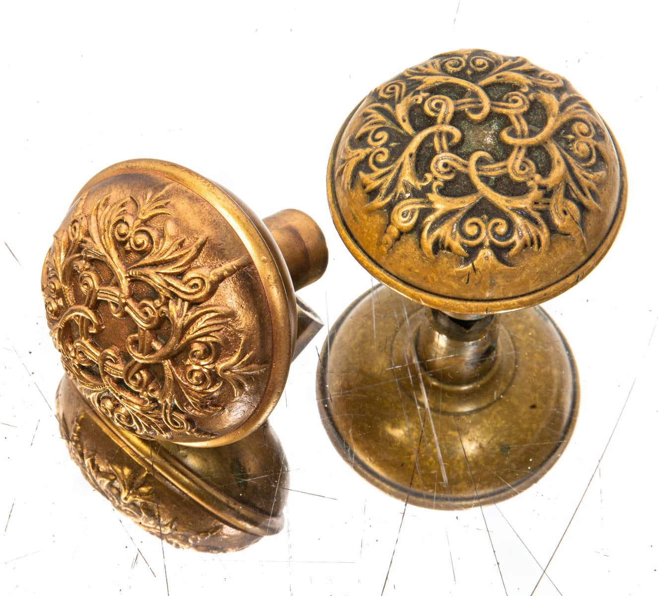 matching set of original late 19th century ornamental cast brass "baltic" pattern banded rim residential doorknobs