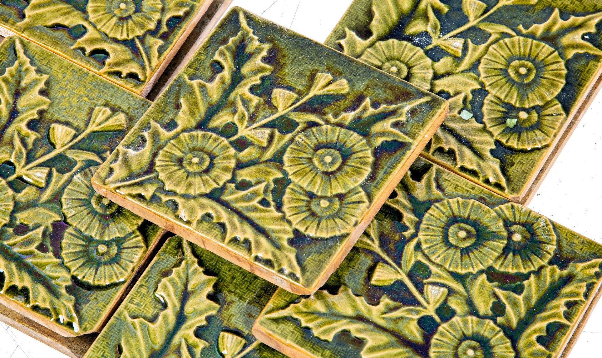 richly colored mottled green majolica glazed "thistle" or "holly" pattern salvaged chicago fireplace tiles