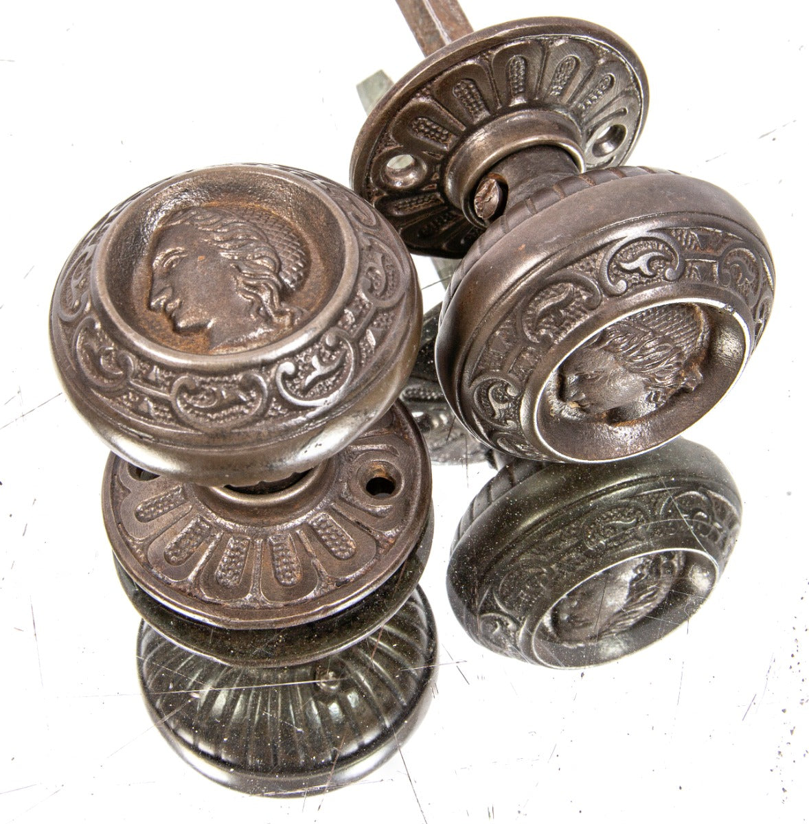 original 1870s antique american victorian-era uniquely-shaped "clara burton" figural cast iron doorknobs with matching rosettes