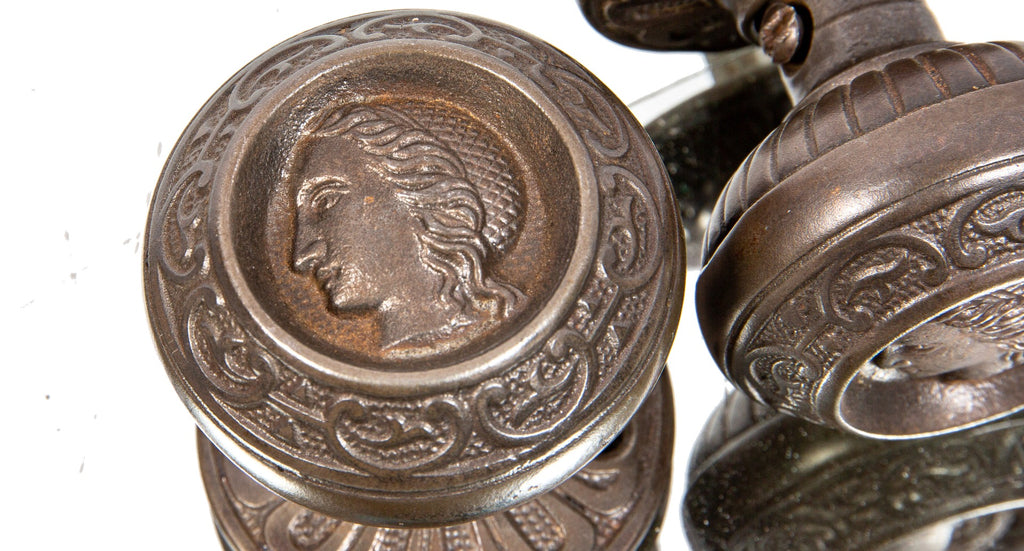 original 1870s antique american victorian-era uniquely-shaped "clara burton" figural cast iron doorknobs with matching rosettes