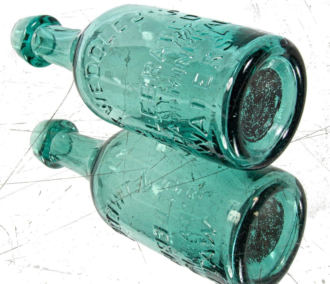 mid-nineteenth century green privy dug american iron-pontiled soda bottle with tapered blobtop manufactured for new york bottler john tweddle jr