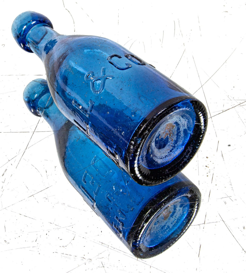 hard to find cornflower blue glass mid to late 1850's iron pontiled soda glass bottle with deeply embossed lettering and applied blob top