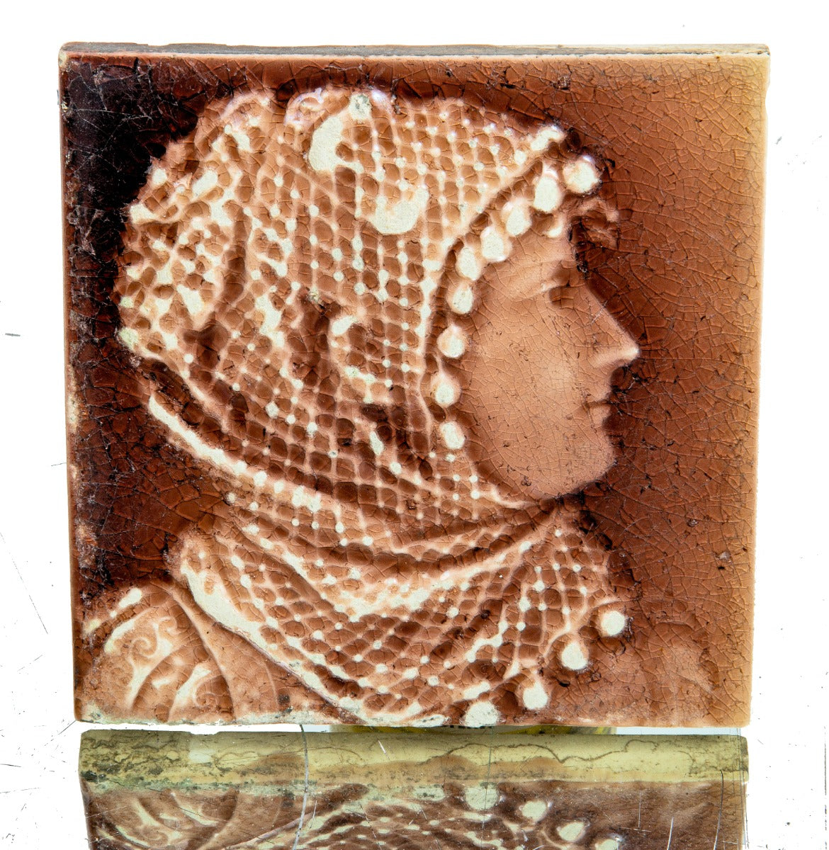 deeply embossed 19th century antique american figural fireplace corner tile with woman wearing head wrap scarf shawl