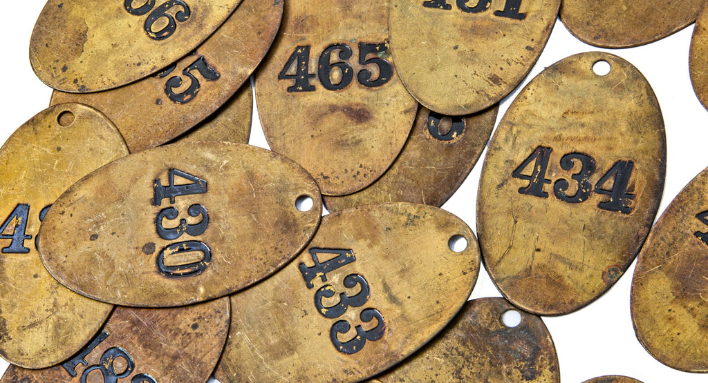 large lot of early 20th century ywca hotel heavy stamped brass guest room door key fobs with black enameled numbers