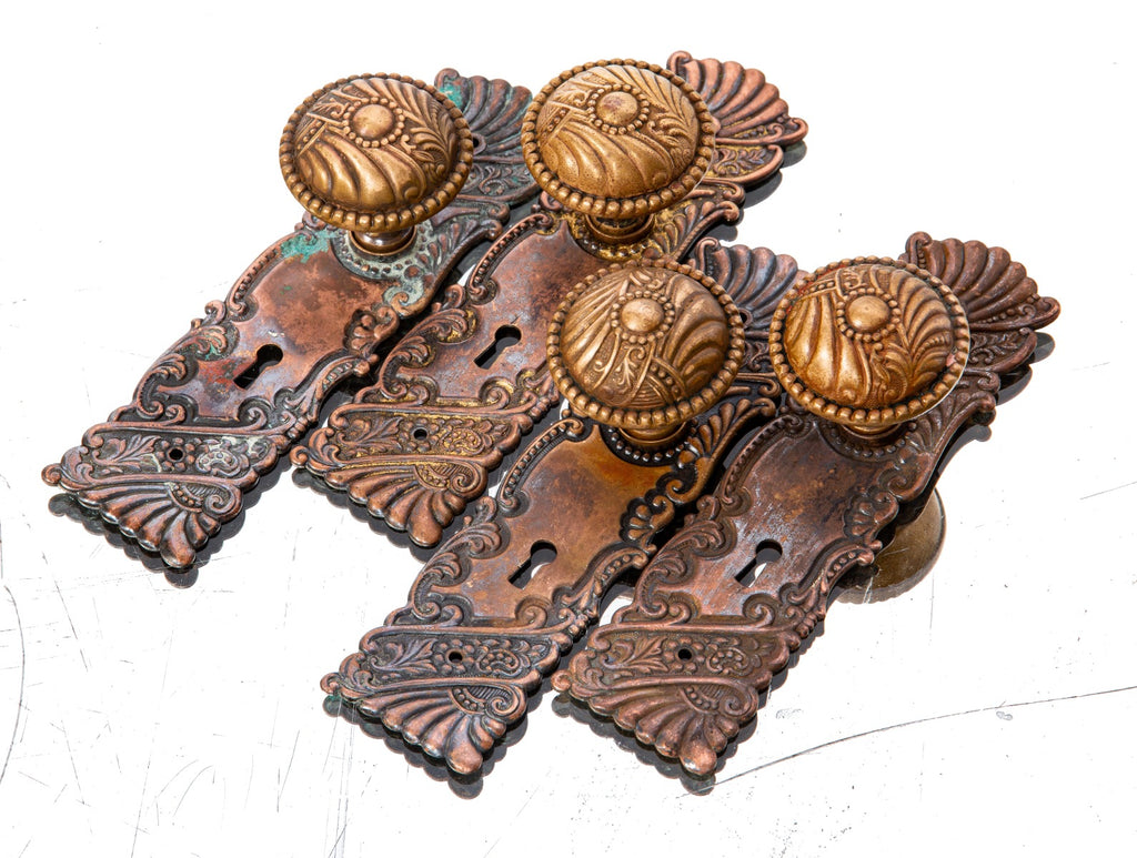 large lot of late 19th century salvaged chicago interior residential ornamental wrought bronze "roanoke" pattern doorknobs and backplates