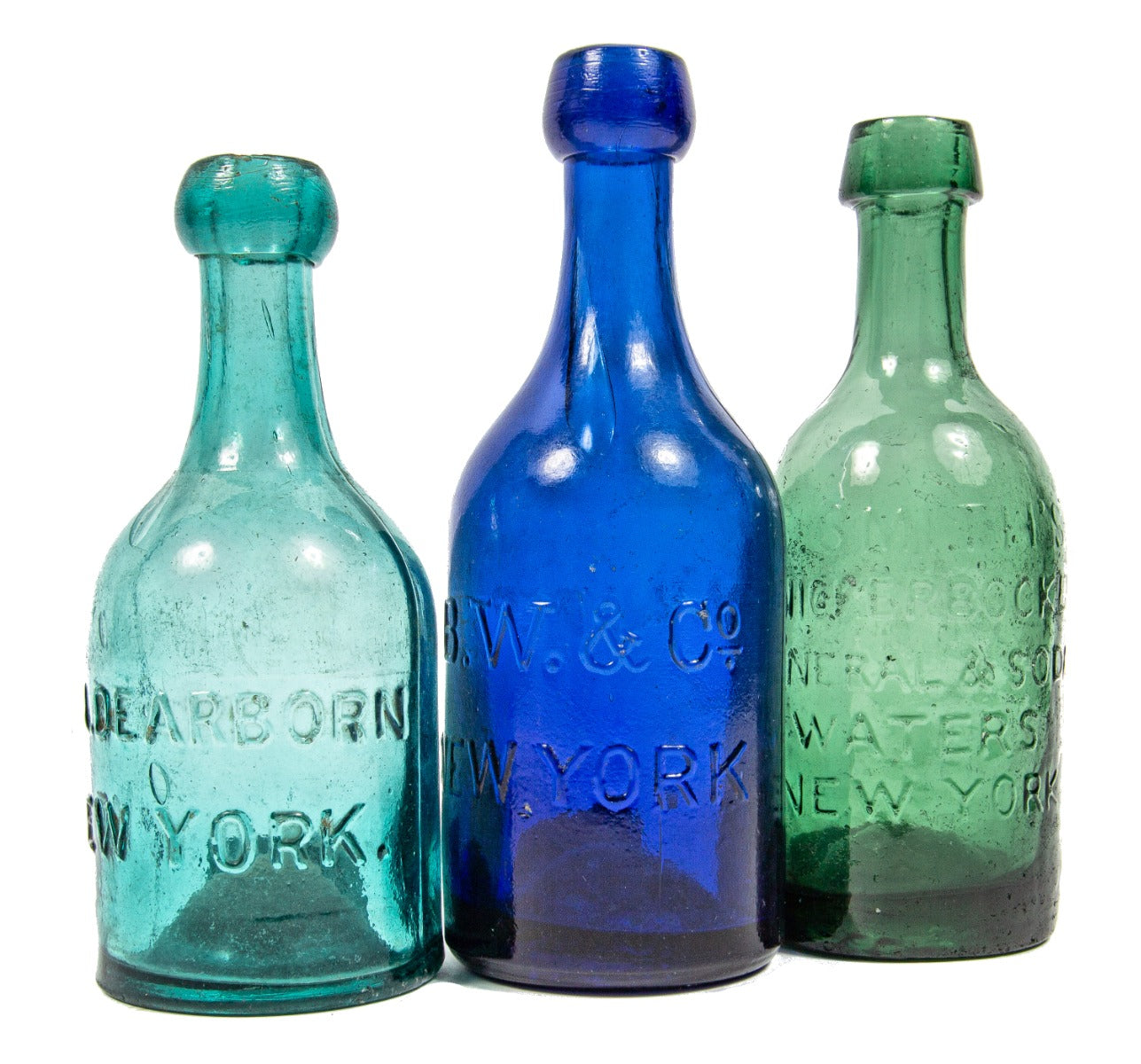 group of three hard to find 1850s new york city privy pit-dug embossed iron-pontiled soda bottles