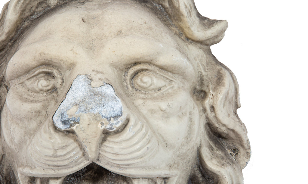 early recast of oversized lionhead used during renovation of george j. johnson's iron block (1860)