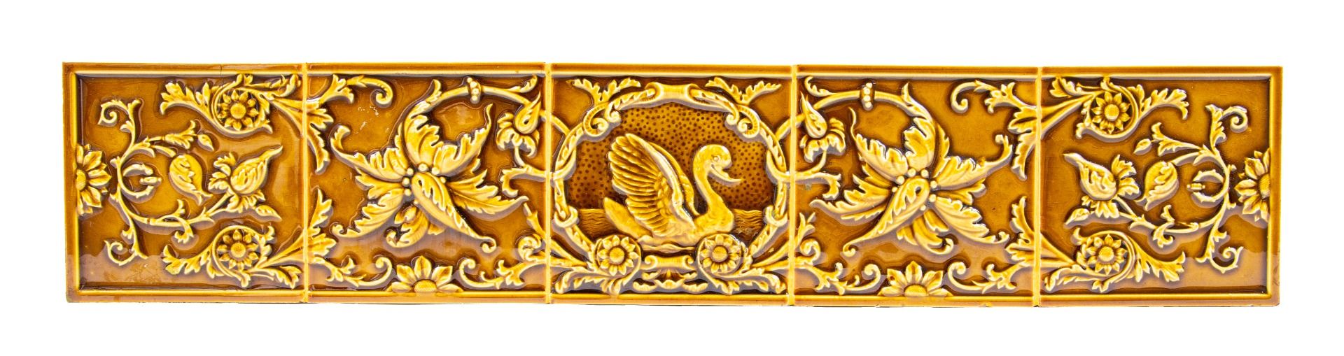 late 19th century butterscotch-colored majolica glazed five-piece tile set with swan and floral motifs