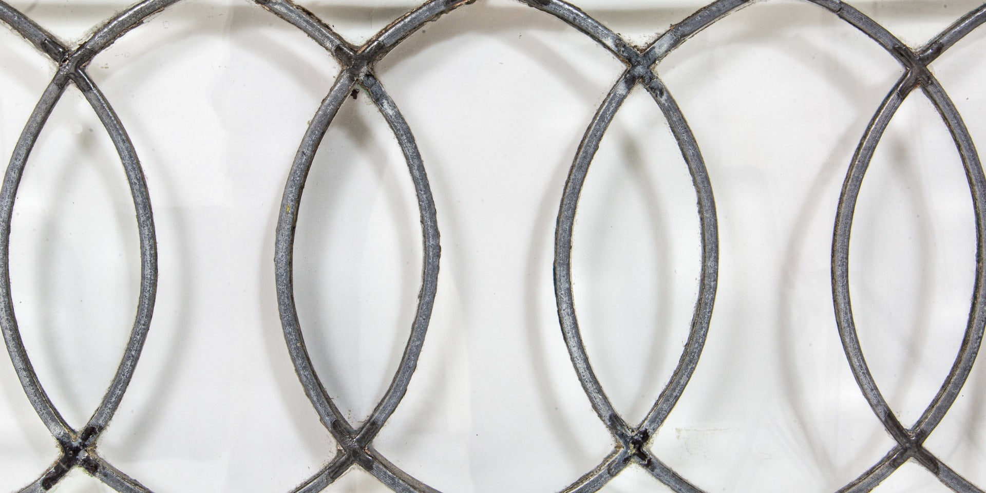 important late 19th century strongly geometric leaded clear glass robert p. parker "bootleg" house window featuring bands of overlapping ovals