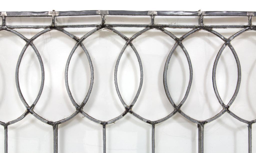 important late 19th century strongly geometric leaded clear glass robert p. parker "bootleg" house window featuring bands of overlapping ovals