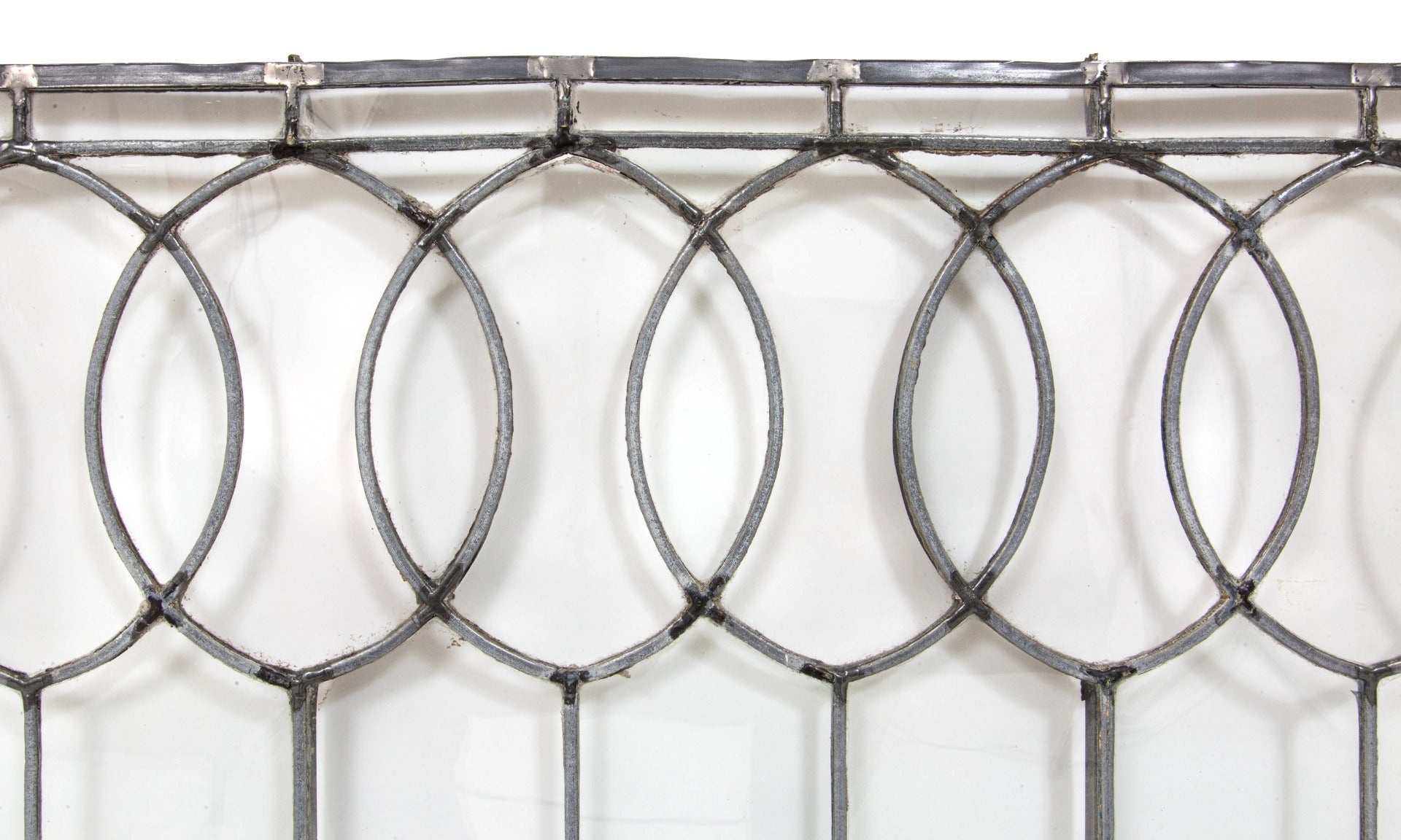 important late 19th century strongly geometric leaded clear glass robert p. parker "bootleg" house window featuring bands of overlapping ovals