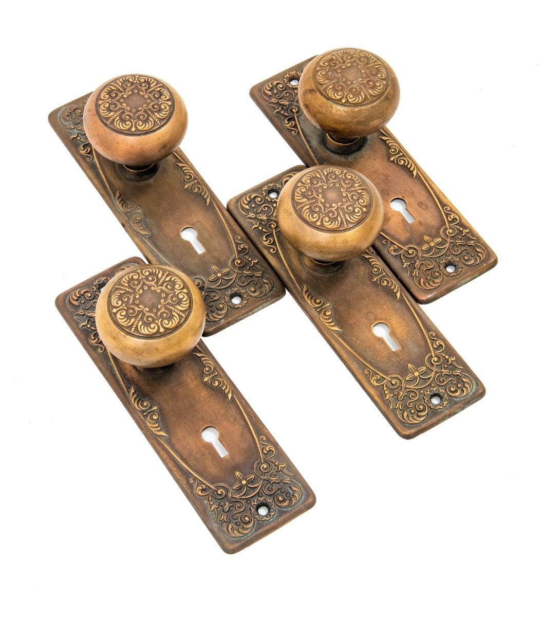matching lot of hard to find original early 20th century ornamental cast brass "alexandria" pattern doorknobs and matching backplates